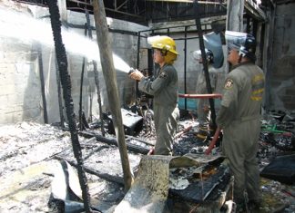 Firefighters put out the last few embers of a horrific fire that took too lives at the Music Studio in Duck Square.